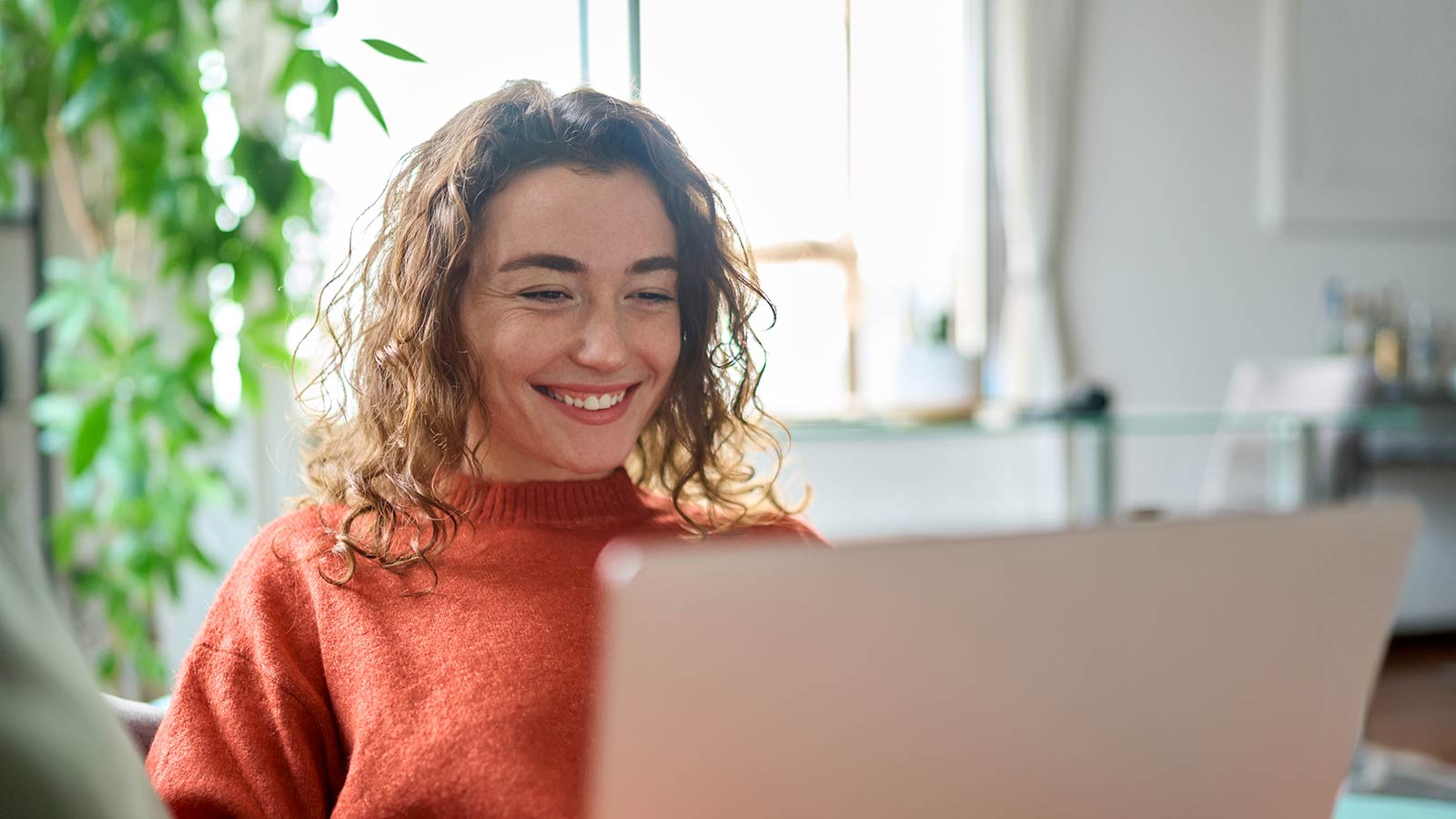 Kvinde tjekker sin årsopgørelse Kvinde sidder og kigger på sin computer